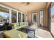 Comfortable outdoor patio with lounge seating and ceiling fan, perfect for relaxing or entertaining at 7763 Brisk Ocean Ave, Las Vegas, NV 89178