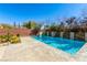 Sparkling pool surrounded by lush landscaping and a serene waterfall feature for a tranquil outdoor oasis at 7763 Brisk Ocean Ave, Las Vegas, NV 89178