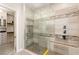 Step into this luxurious walk-in shower with floor-to-ceiling tile and stylish fixtures, adjacent to a walk-in closet at 7763 Brisk Ocean Ave, Las Vegas, NV 89178