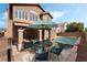 Inviting backyard with a sparkling pool, covered patio, and dining area for outdoor enjoyment at 7837 Silver Plateau Ave, Las Vegas, NV 89128