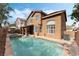 Spacious backyard with a pool, covered patio, and lush landscaping, perfect for relaxation at 7837 Silver Plateau Ave, Las Vegas, NV 89128