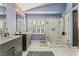 Bright ensuite bathroom features a marble tiled floor, dual sink vanity, and glass enclosed shower at 7837 Silver Plateau Ave, Las Vegas, NV 89128