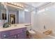 Charming bathroom with shower-tub combo, purple vanity, and bright natural light at 7837 Silver Plateau Ave, Las Vegas, NV 89128