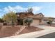 Charming two-story home features a well-manicured front yard with mature trees and a stone pathway to the front door at 7837 Silver Plateau Ave, Las Vegas, NV 89128