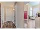 A hallway showcases hardwood flooring, neutral walls, and a glimpse into other rooms, creating a cohesive living space at 7837 Silver Plateau Ave, Las Vegas, NV 89128
