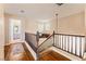 Upstairs hallway with wood floors, a staircase, and access to other rooms at 7837 Silver Plateau Ave, Las Vegas, NV 89128