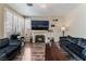 This living room features hardwood floors, a fireplace, and comfortable couches at 7837 Silver Plateau Ave, Las Vegas, NV 89128