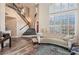 Elegant living room with a grand staircase, plantation shutters, and neutral colors offers a bright and airy ambiance at 7837 Silver Plateau Ave, Las Vegas, NV 89128