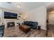 This is a cozy living room featuring hardwood floors, a fireplace, and a couch at 7837 Silver Plateau Ave, Las Vegas, NV 89128