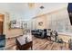 This living room has wood floors, many windows with plantation shutters, and a chandelier at 7837 Silver Plateau Ave, Las Vegas, NV 89128