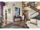The living room features beautiful hardwood floors, a staircase, and tasteful decor for an inviting and comfortable atmosphere at 7837 Silver Plateau Ave, Las Vegas, NV 89128