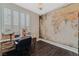This is an office that features a wooden desk and world map on the wall at 7837 Silver Plateau Ave, Las Vegas, NV 89128
