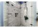 Ensuite shower with marble tiling, overhead nozzle and recessed shampoo and soap niche at 7837 Silver Plateau Ave, Las Vegas, NV 89128