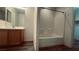 Bathroom featuring a vanity with wood cabinetry, a mirror, and a tub-shower combination at 7985 Flower Seeds St, Las Vegas, NV 89139