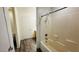 Bright bathroom featuring tub-shower combination, tiled walls, and neutral color palette at 7985 Flower Seeds St, Las Vegas, NV 89139