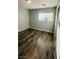 Bright bedroom with wood-look floors and window; also features sliding glass door at 7985 Flower Seeds St, Las Vegas, NV 89139