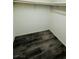 Compact walk-in closet featuring wood-look flooring at 7985 Flower Seeds St, Las Vegas, NV 89139