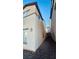 Side view of the home shows the exterior walls and narrow space to the adjacent property at 7985 Flower Seeds St, Las Vegas, NV 89139
