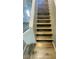 Interior staircase featuring updated wood flooring and modern design elements at 7985 Flower Seeds St, Las Vegas, NV 89139