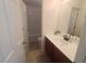 This bathroom features a shower-tub combo and a single sink vanity with dark wood cabinets and tile flooring at 8957 Rufina St, Las Vegas, NV 89148