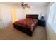 Bedroom features a dark wood bedframe with carpet flooring, natural light, and a ceiling fan at 8957 Rufina St, Las Vegas, NV 89148