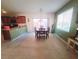 Open-concept dining area next to kitchen with tiled floor, slider door, and warm, natural light at 8957 Rufina St, Las Vegas, NV 89148