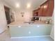 Bright kitchen featuring stainless steel appliances, wood cabinetry, and an island with a sink at 8957 Rufina St, Las Vegas, NV 89148