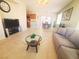 Open-concept living room with kitchen and dining area featuring tile flooring and a comfortable layout at 8957 Rufina St, Las Vegas, NV 89148