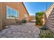 Private backyard patio with beautiful brick flooring, mature landscaping and wrought iron furniture at 9076 Bridal Creek Ave, Las Vegas, NV 89178