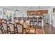 Spacious dining room with hardwood floors, elegant furniture, flowing into the modern kitchen and bar area at 9076 Bridal Creek Ave, Las Vegas, NV 89178