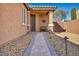 Charming front entrance featuring a landscaped walkway, decorative door, and a cozy bench at 9076 Bridal Creek Ave, Las Vegas, NV 89178