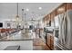 Bright, modern kitchen featuring stainless steel appliances, granite countertops, and wood cabinets at 9076 Bridal Creek Ave, Las Vegas, NV 89178