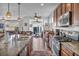 Modern kitchen features granite countertops, stainless steel appliances and open floor plan at 9076 Bridal Creek Ave, Las Vegas, NV 89178