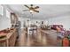 Open-concept living space with a kitchen island, dining table, and comfortable seating area at 9076 Bridal Creek Ave, Las Vegas, NV 89178