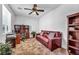 The home office includes a comfortable couch, built-in shelving, and lots of light at 9076 Bridal Creek Ave, Las Vegas, NV 89178