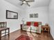 The bright sitting room features wood flooring, comfortable seating, and natural light at 9076 Bridal Creek Ave, Las Vegas, NV 89178