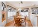 Breakfast nook featuring wood floors, wood table and chairs and many windows at 9308 Quail Ridge Dr, Las Vegas, NV 89134