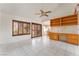 Bright living room featuring tile floors, high ceilings, shutters, and built-in cabinets at 9308 Quail Ridge Dr, Las Vegas, NV 89134