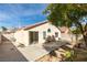 Backyard with a concrete patio, desert landscaping, mature trees, and block wall at 9378 Spellman Ct, Las Vegas, NV 89123