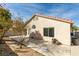 Rear exterior featuring stucco, a red tile roof, a covered patio, desert landscaping, and block wall at 9378 Spellman Ct, Las Vegas, NV 89123
