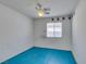 Spare bedroom with a fan, a window for light, and teal colored flooring at 9378 Spellman Ct, Las Vegas, NV 89123