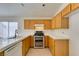 Bright kitchen featuring wooden cabinets, tile counters, a tile floor and a stainless steel oven range at 9378 Spellman Ct, Las Vegas, NV 89123