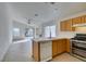 Bright kitchen features tile floors, stainless steel appliances, and breakfast bar seating at 9378 Spellman Ct, Las Vegas, NV 89123
