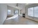 Open living room with tile flooring, fireplace, fan, and sliding glass door to backyard at 9378 Spellman Ct, Las Vegas, NV 89123
