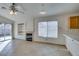 Open living room with fireplace and tile flooring leads to the kitchen area and backyard at 9378 Spellman Ct, Las Vegas, NV 89123