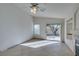 Open living room boasts tile flooring, a ceiling fan, and a slider to backyard at 9378 Spellman Ct, Las Vegas, NV 89123