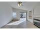 Open living room boasts tile flooring, a ceiling fan, and a slider to backyard at 9378 Spellman Ct, Las Vegas, NV 89123