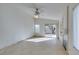 Open living room boasts tile flooring, a ceiling fan, and a slider to backyard at 9378 Spellman Ct, Las Vegas, NV 89123
