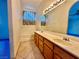 Main bathroom featuring a dual sink vanity, a mirror, and a shower-tub combination at 9378 Spellman Ct, Las Vegas, NV 89123