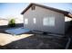 Backyard showing the side of the home and patio area with a block wall for added privacy at 9424 Fox Forest Ave, Las Vegas, NV 89129